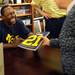Michigan football star Desmond Howard laughs as he chats with a fan during an autograph signing at the M Den on Friday.  Melanie Maxwell I AnnArbor.com